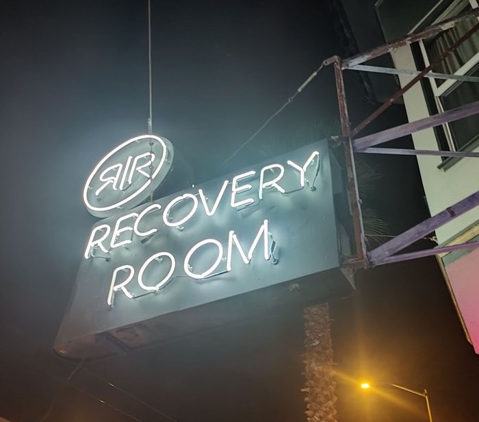 Recovery Room neon sign at night